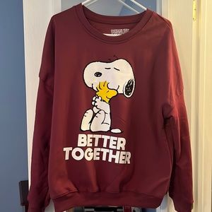 Maroon colored Peanuts sweatshirt.